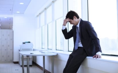 A young businessman having a panic attack in an office. Panic disorder is a condition in which a person has sudden episodes of intense fear or anxiety. These episodes are known as panic attacks.