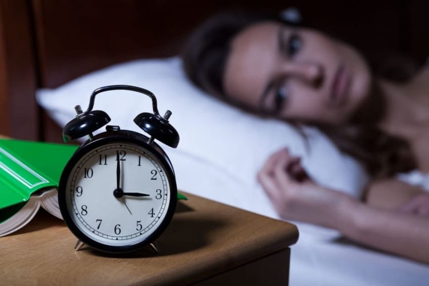 A woman lying in bed stares at clock in the middle of the night. Insomnia is a sleep disorder where people have trouble falling asleep, staying asleep, or both. It’s more common in older adults and women.