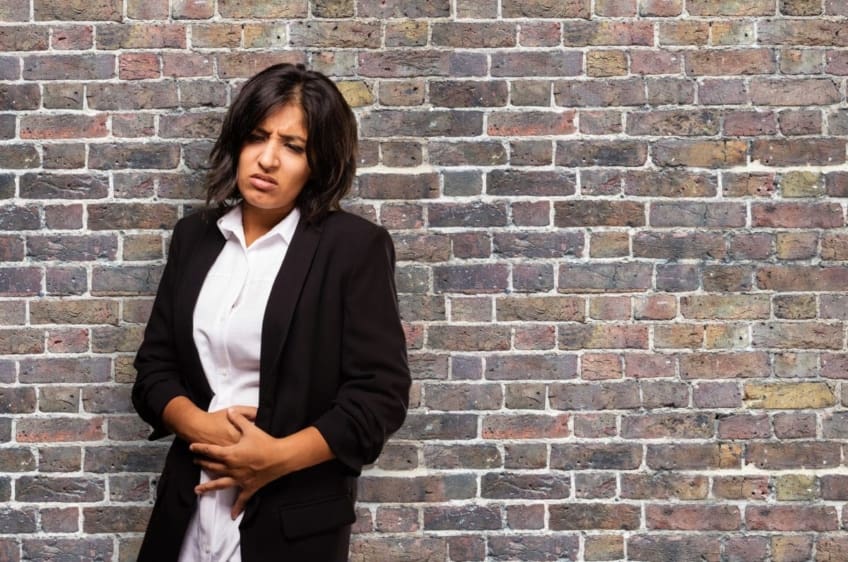 Woman holding stomach in pain