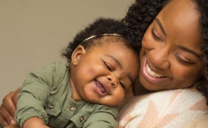 close-up of mother hugging her baby daughter
