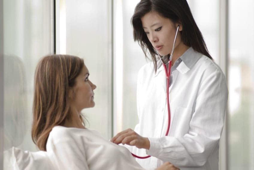 A doctor uses a stethoscope to listen to woman’s heart. Mitral valve prolapse is a heart condition in which the flaps of the mitral valve don’t close properly. Most who have it don’t need treatment.