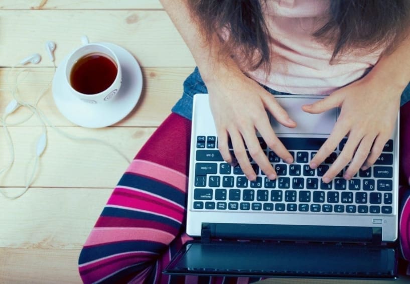 young woman sitting with a laptop