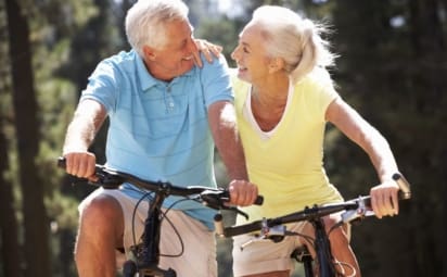 A older couple biking together outdoors