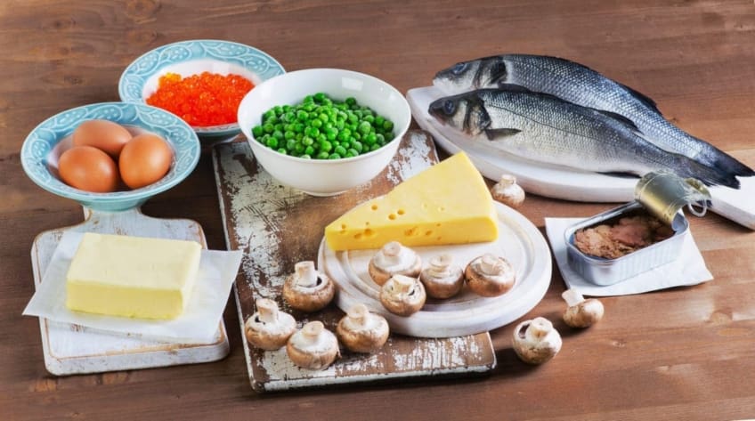 Fish, eggs, dairy products and vegetables sitting on table. Vitamin D is a nutrient that helps your body build strong bones and teeth. You can get it from foods, sunlight, and dietary supplements.