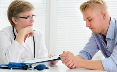 Doctor talking to male patient about mental health.