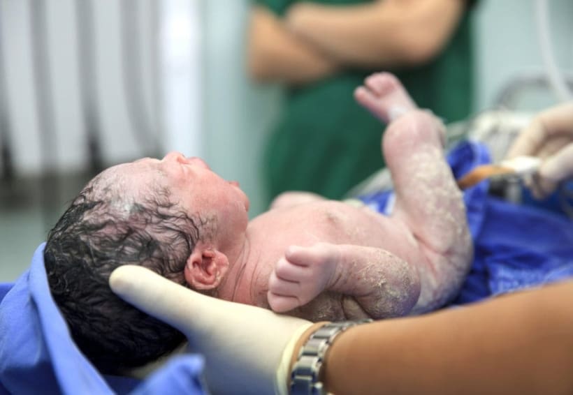 Nurse holding newborn