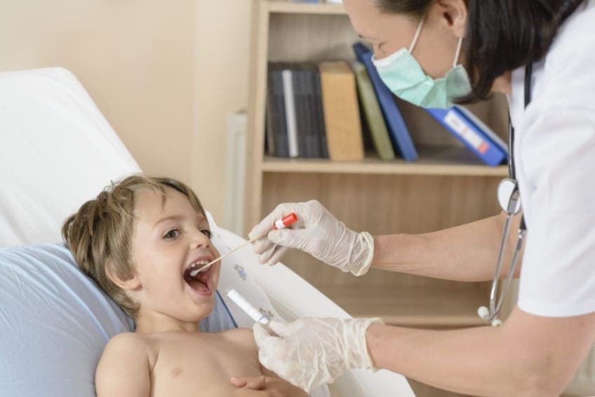 Nurse checking child's throat
