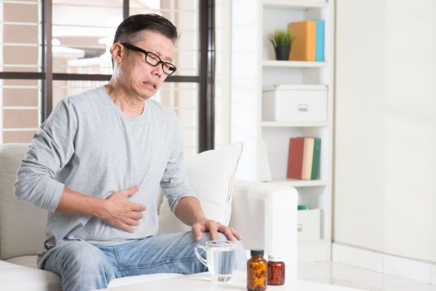 Man holding his stomach in pain