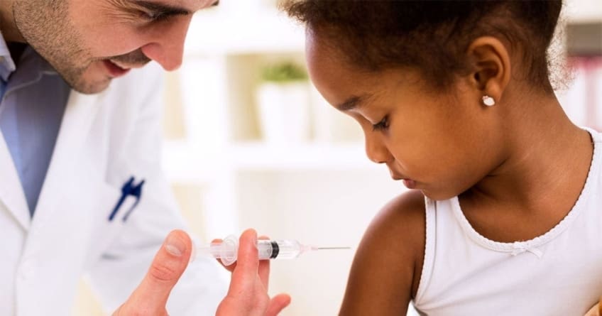 Doctor injects vaccine into a child's arm