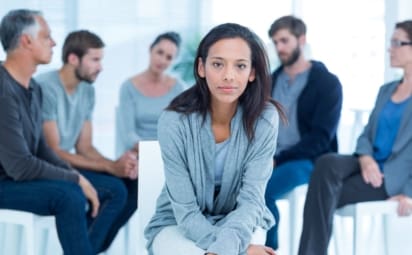 Woman in rehab group at a therapy session.